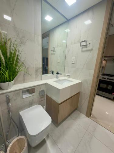 a bathroom with a sink and a toilet and a mirror at Beautiful Studio Retreat in Ras al Khaimah