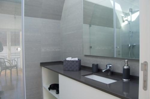 a bathroom with a sink and a mirror at Casa do Chafariz in Cascais