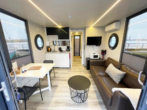 a living room with a couch and a table at Fjord Lyckholm in Schleswig
