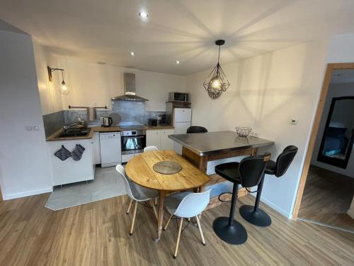a kitchen and dining room with a table and chairs at Le balcon du Chemin des Vignes ! in Bozel