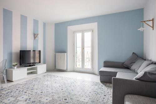 a living room with a couch and a tv at Saragozza Apartments - Bologna Short Rental in Bologna