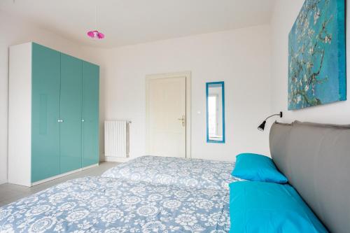 a bedroom with a bed and a blue cabinet at Saragozza Apartments - Bologna Short Rental in Bologna