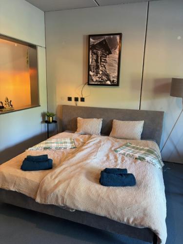 a large bed with two blue pillows on it at Appartement Weiskopf in Reith bei Seefeld