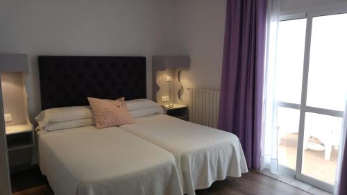 Cama ou camas em um quarto em Campomar Playa