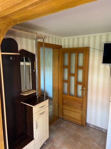 a room with a mirror and a wooden door at Guest House Naglis in Neringa