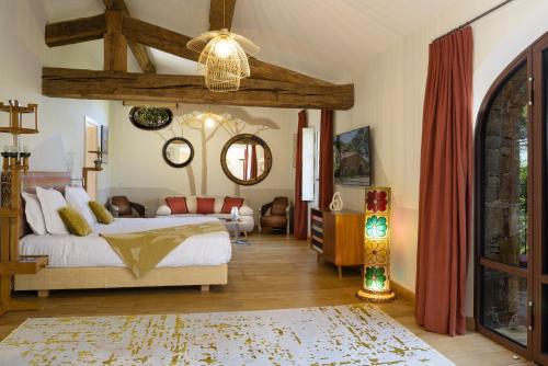 a bedroom with a bed and a living room at Domaine Les Mésanges in Saint-Tropez