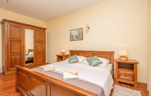 a bedroom with a large bed with two towels on it at Villa Ruzin Dvor in Donji Vinjani