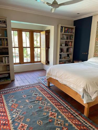 a bedroom with a bed and a book shelf at Classic Home in Franschhoek in Franschhoek