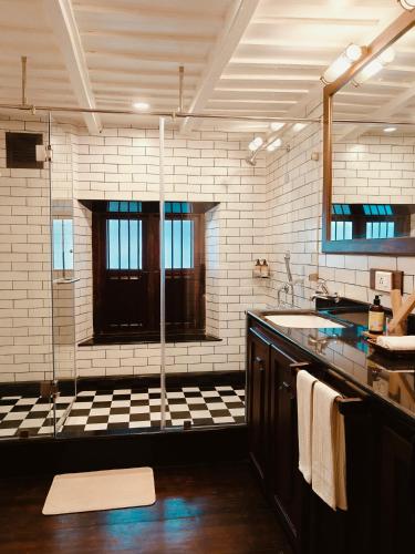 a large bathroom with a sink and a window at Ezekiel House Residence in Cochin