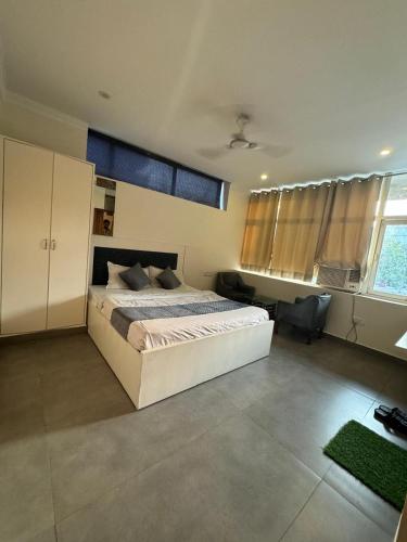 a bedroom with a white bed and a window at Hotel Chandigarh Elite in Chandīgarh