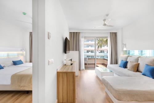 a bedroom with a bed and a living room with a couch at Metropolitan Juka Playa in Playa de Palma