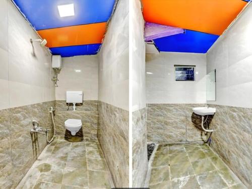 a bathroom with a blue and orange ceiling at HOTEL Sarovar in Ahmedabad