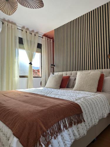 a bedroom with a large bed with a window at Serenity Stone en las Sierras in Benaoján
