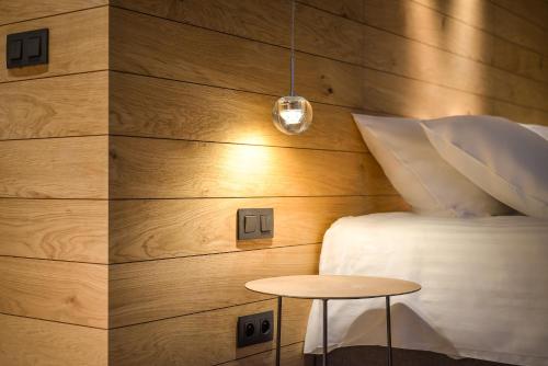 a bedroom with a bed and a table at R hotel experiences in Sougné-Remouchamps