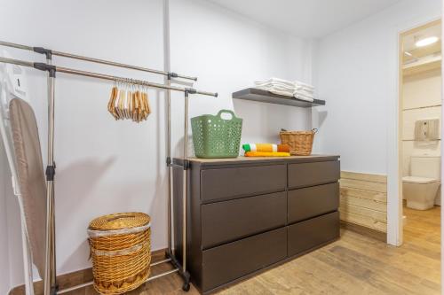 a bathroom with a black dresser and a toilet at Las Palmeras 2 in Güimar