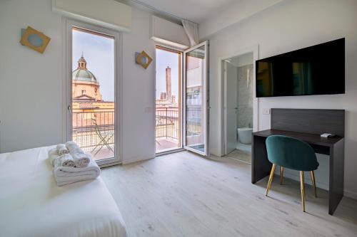 a bedroom with a bed and a desk and a window at Urbanicooh Cavour Rooms&Suite in Bologna