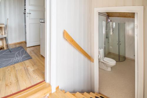 a bathroom with a toilet and a glass shower at Lysø naturcamping og rorbuer in Averoy