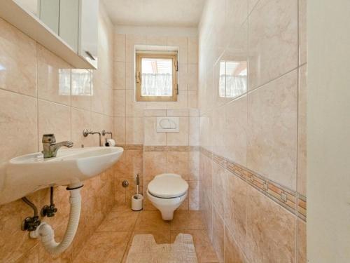 a bathroom with a white toilet and a sink at Ivanka A2 in Dajla