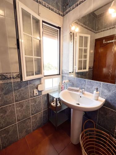 a bathroom with a white sink and a window at Nueva Villa Ignacia in Arriate