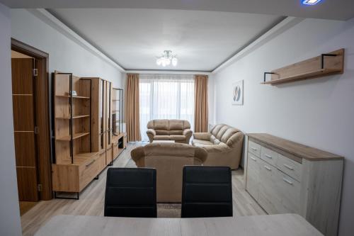 a living room with a couch and chairs and a table at Barrique 30 - Breakfast Delivered & Minibar - Free parking - Mall Area in Braşov