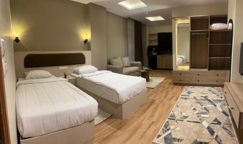 a bedroom with two beds and a living room at Regal view Aparthotel in Cairo