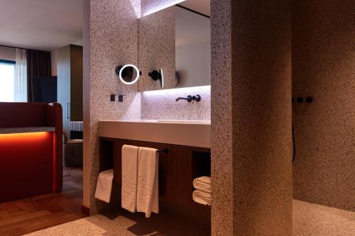 a bathroom with a sink and a mirror at Hotel Baia Verde in Malcesine