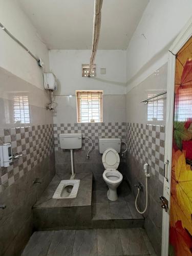 a bathroom with a toilet and a sink at Sunlight Premium in Bhubaneshwar