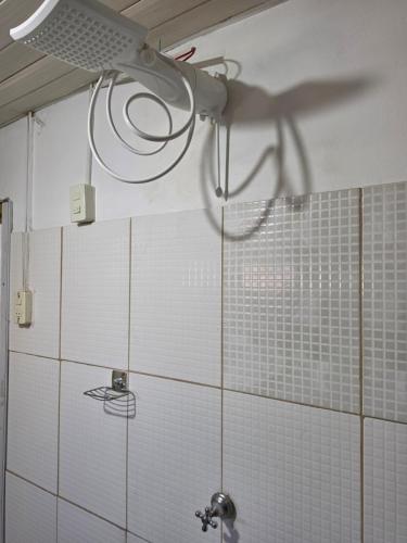 a shower in a bathroom with a shower head at Ypane Residencial in Ypane