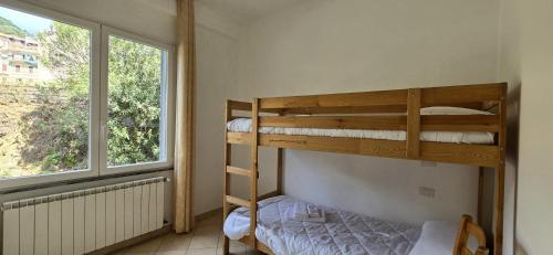 a bedroom with two bunk beds and a window at Monterosso - Apartment in Monterosso al Mare