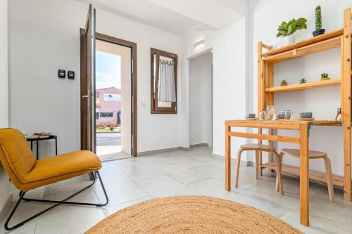 a living room with a desk and a chair at Ghjlgolu Suites - Essential Stay in Monte Petrosu
