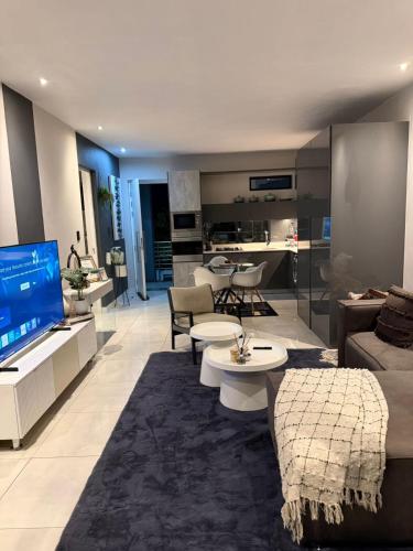 a living room with a couch and a tv and a living room at The paramount houghton Zayna in Johannesburg