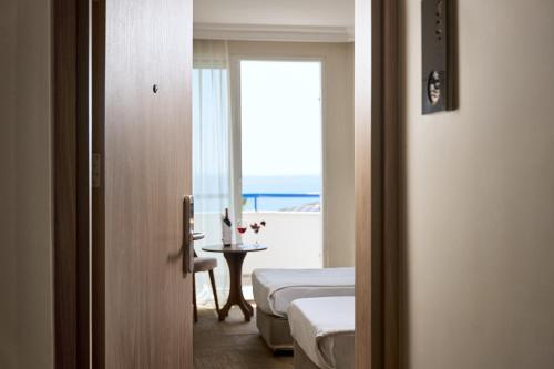 a hotel room with two beds and a view of the ocean at Elysee Beach Hotel in Alanya