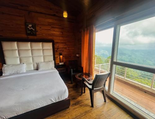 a bedroom with a bed and a large window at Eden Resort By Live Inn in Lansdowne