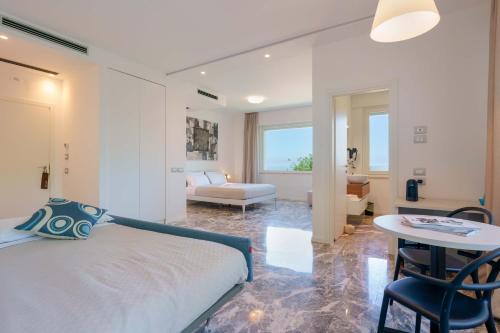 a bedroom with a bed and a table and a couch at Le Relais du Lierre - Conero Nature Retreat in Poggio