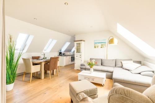 a living room with a couch and a table at Himmelreich in Westerland