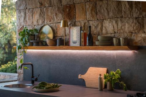 a kitchen counter with a sink and a shelf at Olive Spa Oasis with Private Jacuzzi and Summer Kitchen in Orasac