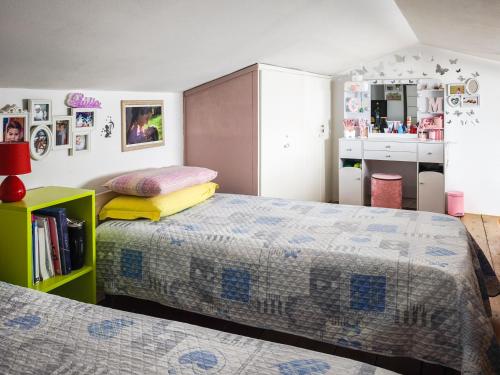 a bedroom with two beds and a cabinet at Magic DaLu House in Olbia