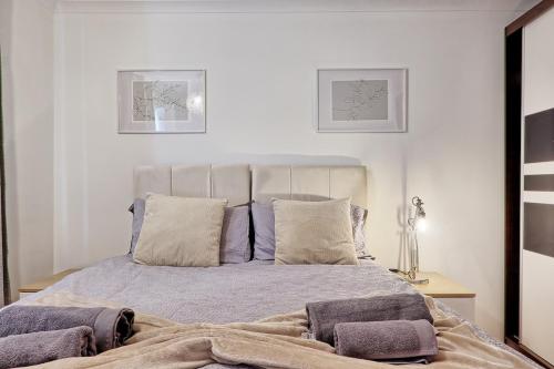a bedroom with a bed with purple blankets and pillows at 1 bed, office space, private parking, contractors in Chelmsford