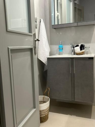 a bathroom with a sink and a mirror at Amalize Luxury Apartments in Karistos