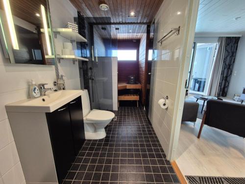 a bathroom with a toilet and a sink and a shower at Timantti Apartments by Hiekka Booking in Kalajoki