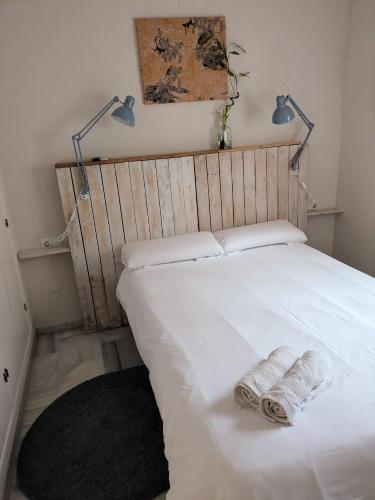 a bedroom with a bed with two towels on it at Casa Micho in Tomares