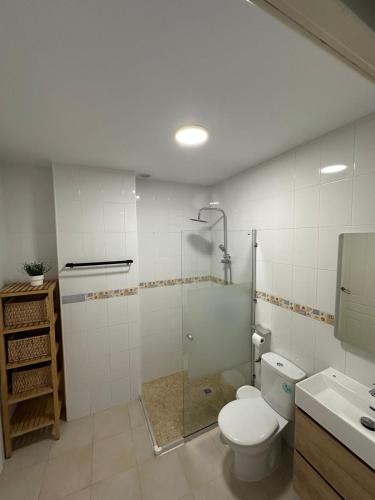 a bathroom with a toilet and a shower and a sink at Casa Atalaya Playa R&R in Aguadulce