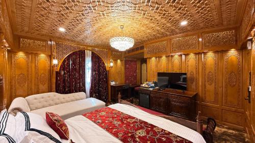 a bedroom with a bed and a tv in a room at Suroor Houseboat in Srinagar