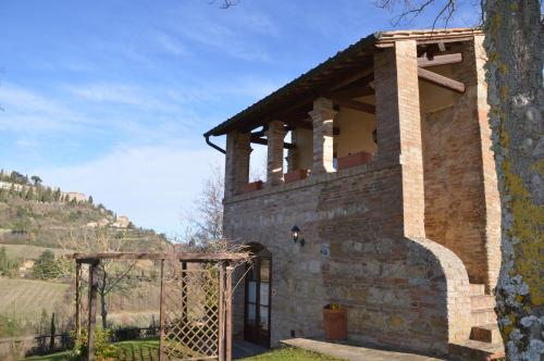 a brick building with a gate and a fence at Agriturismo Nobile in Montepulciano