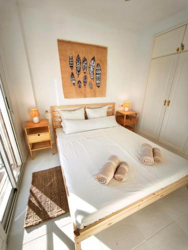 a bedroom with a bed with two slippers on it at Bungalow con Encanto in Torrevieja