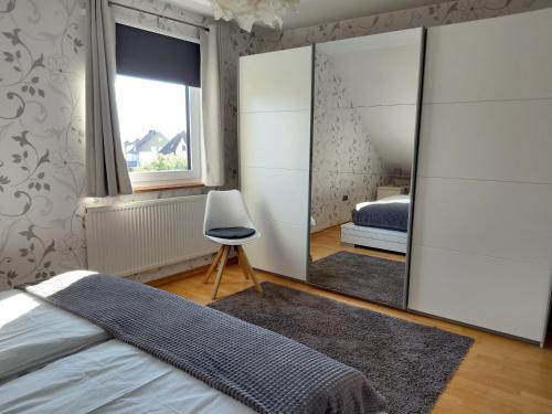 a bedroom with a mirror and a bed at Ferienwohnung am Sendberg in Frielendorf