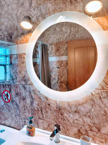 a bathroom with a mirror over a sink at Hermione Horizon in Ermioni