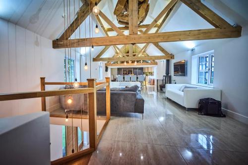 a large living room with a couch and a table at Lower Tundridge Cottage in Worcester