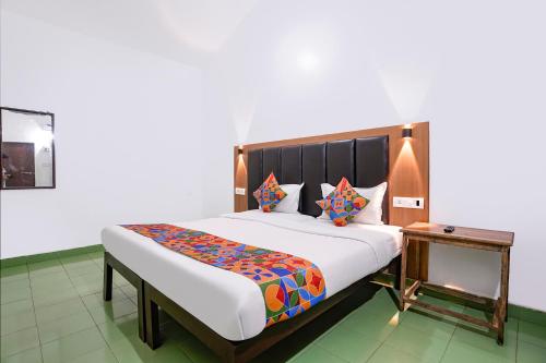 a bedroom with a large bed with a wooden headboard at Via Romeo's Stay - A Beach Property in Baga