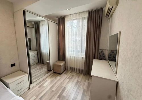 a bedroom with a large mirror and a dresser at Republic Square Modern Flat in Yerevan